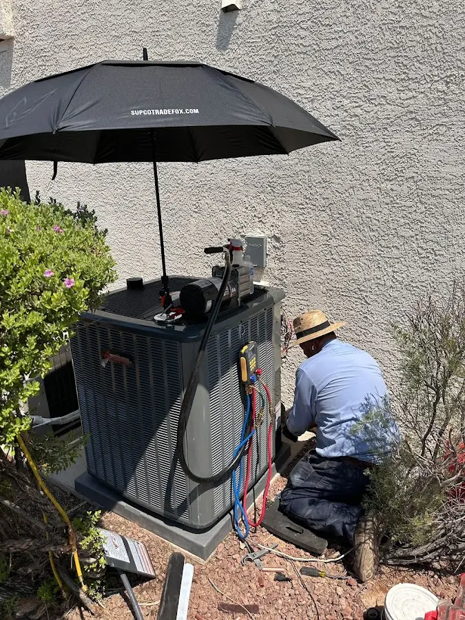 HVAC technician performing outdoor AC maintenance in Wallington